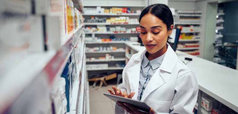 Young,Female,Pharmacist,Checking,Inventory,Of,Medicines,In,Pharmacy,Using